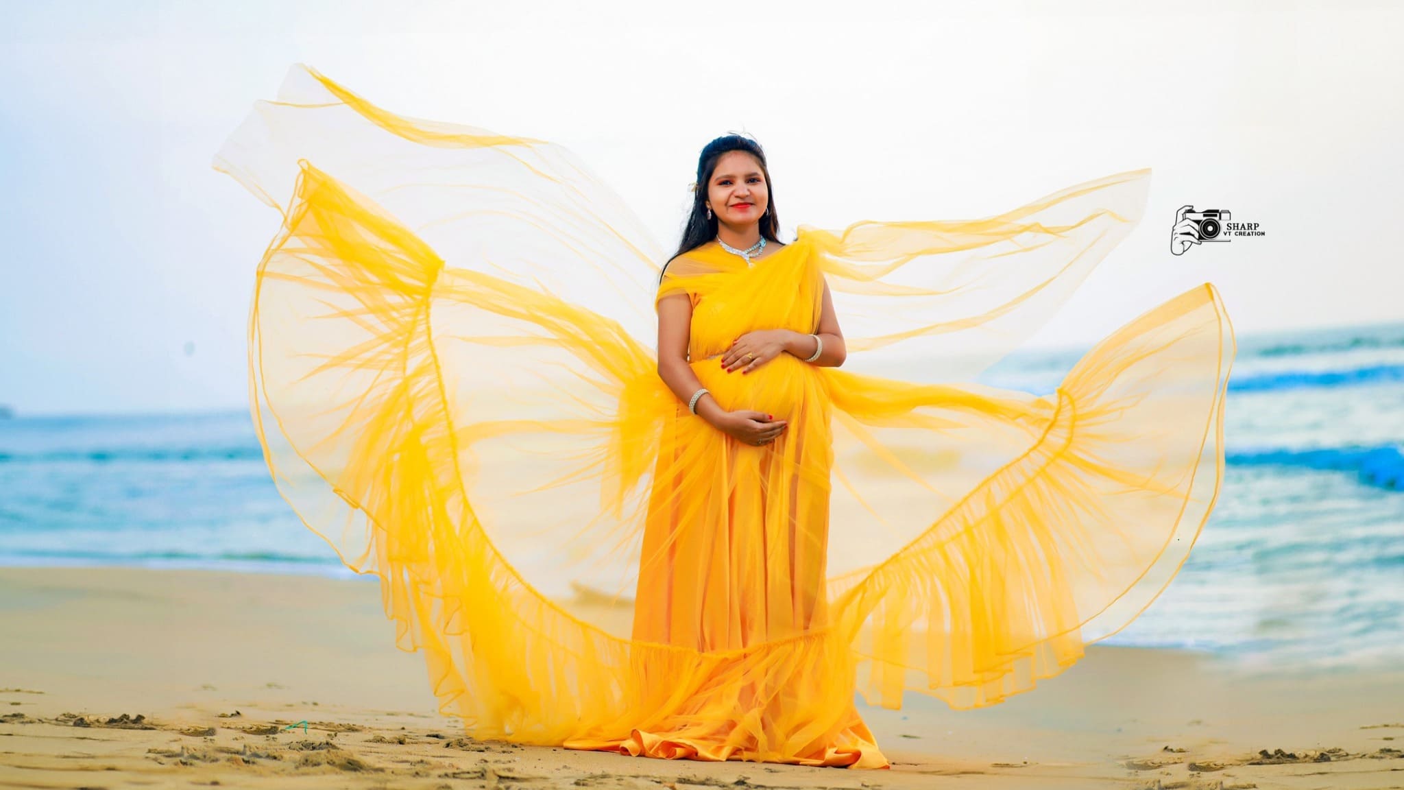 Maternity beach photography in yellow dress
